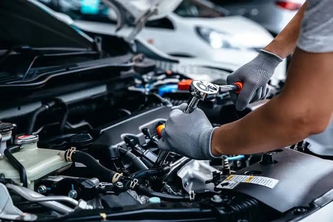 Technician working on an engine in the WrenchWerks service bay